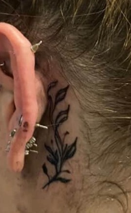 Delicate leaf tattoo behind ear