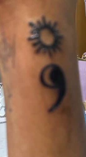 Sun and moon tattoo on side wrist