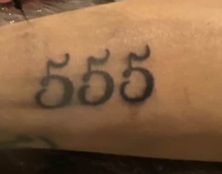 555 numeral tattoo on forearm